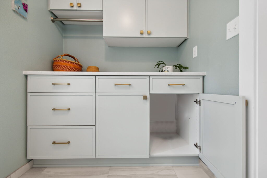 Custom Cabinet with Built-In Laundry Chute in Sea Glass